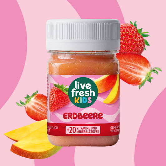 LiveFresh Kids Strawberry in a jar against a pink background with strawberries and mango pieces. The label reads "live fresh KIDS," "STRAWBERRY," and "+20 VITAMINS AND MINERALS."