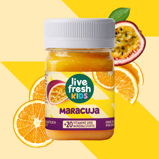 LiveFresh Kids Maracuja in a glass against a yellow background with passion fruit and orange slices. The label reads "live fresh KIDS," "MARACUJA," and "+20 VITAMINS AND MINERALS."