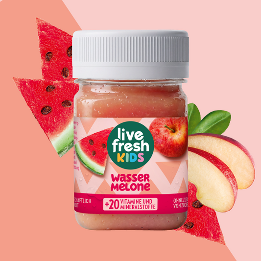 LiveFresh Kids Watermelon in a glass against a pink background with watermelon chunks and apple slices. The label reads “live fresh KIDS,” “WATERMELON,” and “+20 VITAMINS AND MINERALS.”