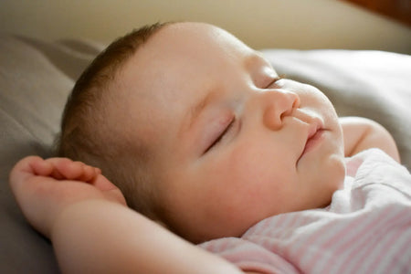 Ein Baby schläft friedlich, was die Bedeutung einer guten Schlafhygiene für erholsamen Schlaf unterstreicht.