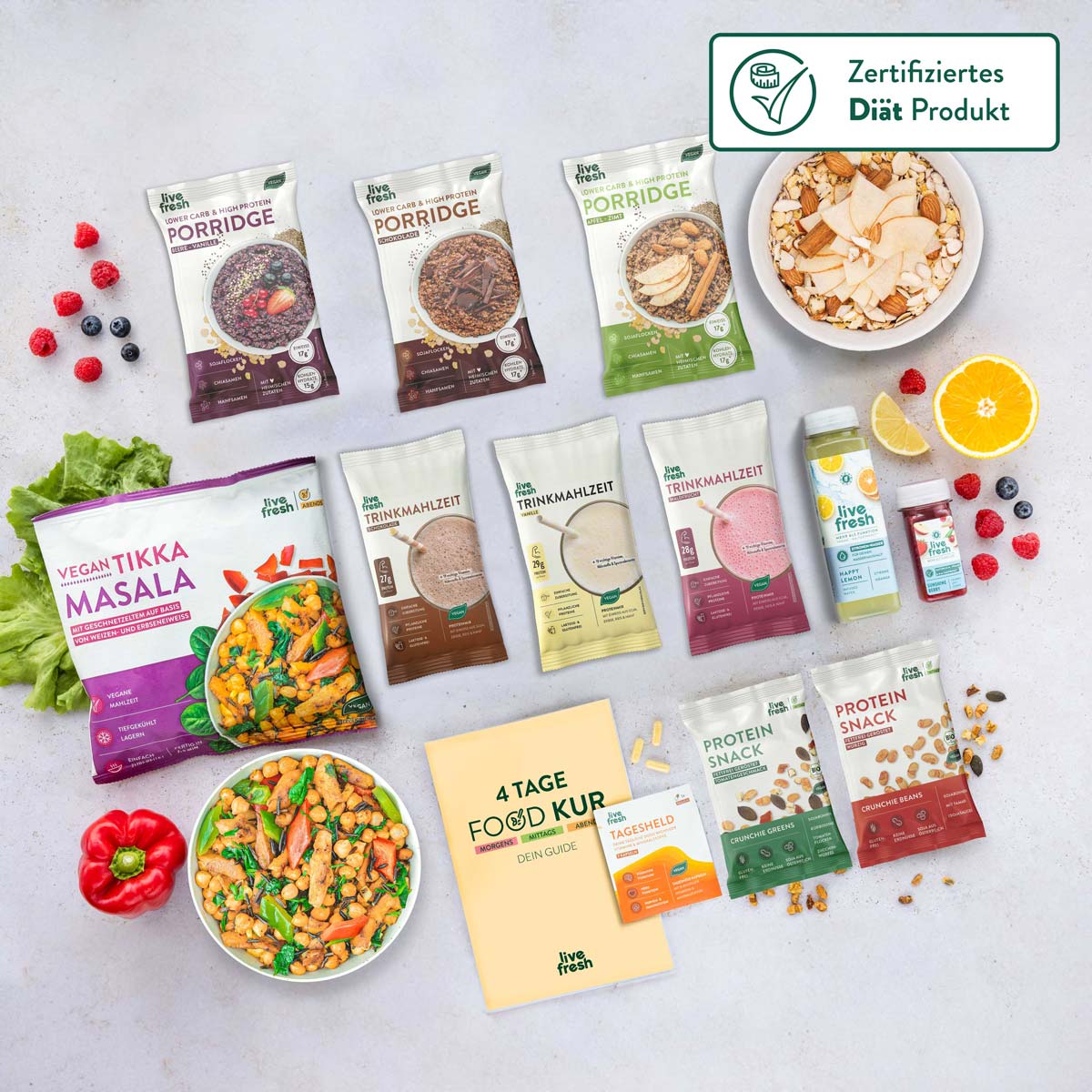 Diverse Auswahl an 'Live Fresh' Produkten, darunter Vegan Tikka Masala, verschiedene Porridge-Packungen und Trinkmahlzeiten auf hellem Untergrund, ideal für eine ausgewogene Ernährung.